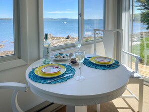 A table set for two with a view of the sea and mountains. - Acadia Bay Cottages (Surry)