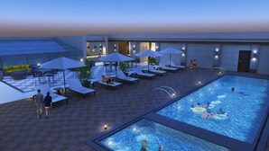 A rooftop pool area with lounge chairs, umbrellas, and a swimming pool. - Four Points by Sheraton Kigali (Kigali)