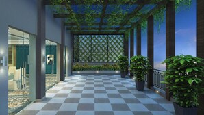 A modern indoor space with a checkered floor, glass partitions, and potted plants. - Four Points by Sheraton Kigali (Kigali)