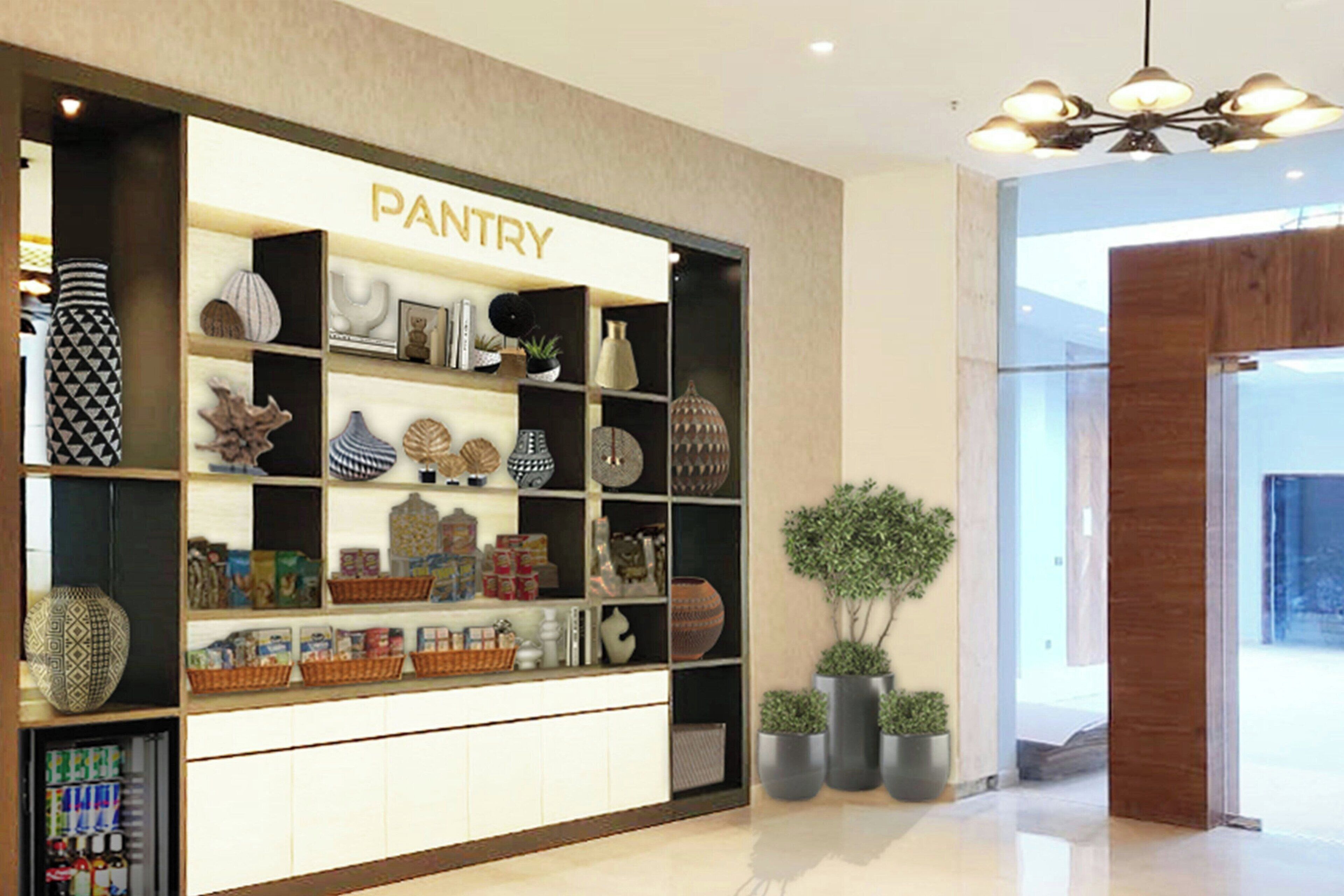 A store named 'PANTRY' with shelves of various items, a potted plant, and a wooden door.