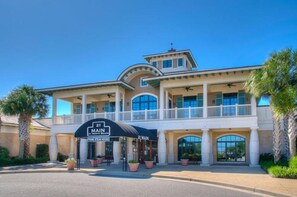 A hotel with a prominent entrance, a covered patio area, and a large balcony.