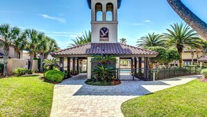 A building with a bell tower, a covered walkway, and a pool area. - Oceanfront 2 Bedroom/2 Bath Windsong (Fernandina Beach)