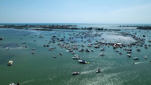 Uma marina com vários barcos atracados e um cais que se estende sobre a água.
