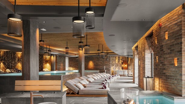 A modern spa with a stone floor, wooden benches, a reception area, and a pool. - Ad Astra by Elite - Hotel, Spa & Resort (Sodertalje)