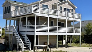 A two-story house with a balcony and a staircase. - Ocean + sound views | Soooo close to the beach! (Duck)
