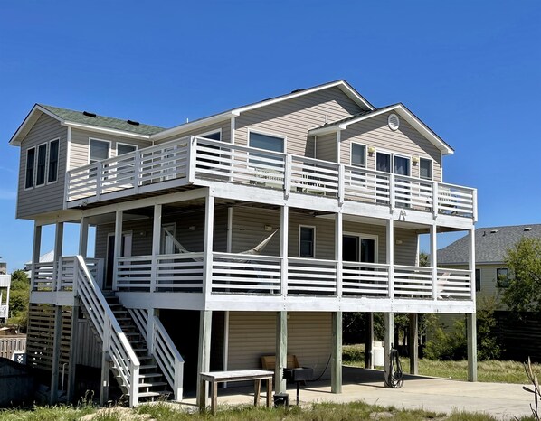 A two-story house with a balcony and a staircase. - Steps to Sand, Miles from Stress (Duck)