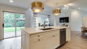 A modern kitchen with a large island, stainless steel appliances, and pendant lighting. - 9 Baynard Cove Road at The Sea Pines Resort (Hilton Head Island)
