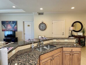 Enjoy cooking in this well-equipped kitchen with a sink and mounted TV.