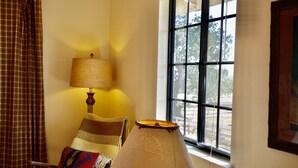A room with a window, a lamp, a chair, and a plaid curtain. - Horse Ranch Guest House above a barn Near Los Olivos for Families & Friends (Santa Ynez)