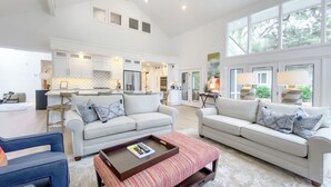 A spacious living area with two sofas, a coffee table, and a dining table. - 9 Sandhill Crane at Sea Pines Resort (Hilton Head Island)