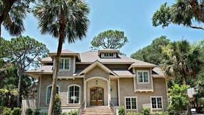 A two-story house with a front entrance, a covered porch, and a landscaped yard. - 12 Green Heron at The Sea Pines Resort (Hilton Head Island)