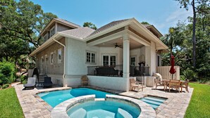 A two-story house with a covered patio area, a swimming pool, and a hot tub. - 12 Green Heron at The Sea Pines Resort (Hilton Head Island)