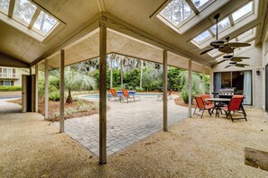 A covered patio with a pool, outdoor seating, and a grill area. - 20 Ruddy Turnstone at The Sea Pines Resort (Hilton Head Island)