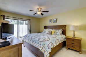 A bedroom with a bed, a desk, a chair, a nightstand, a lamp, and a ceiling fan. - 20 Ruddy Turnstone at The Sea Pines Resort (Hilton Head Island)