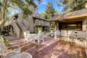 A patio with outdoor furniture, a barbecue area, and a staircase leading to a deck. - 22 Wood Ibis at The Sea Pines Resort (Hilton Head Island)