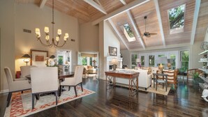 A spacious living area with a high ceiling, a chandelier, and a dining table. - 23 Oyster Landing Road at The Sea Pines Resort (Hilton Head Island)