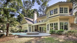 A two-story house with a large front porch, a swimming pool, and a well-maintained garden. - 34 Baynard Cove Rd. at The Sea Pines Resort (Hilton Head Island)