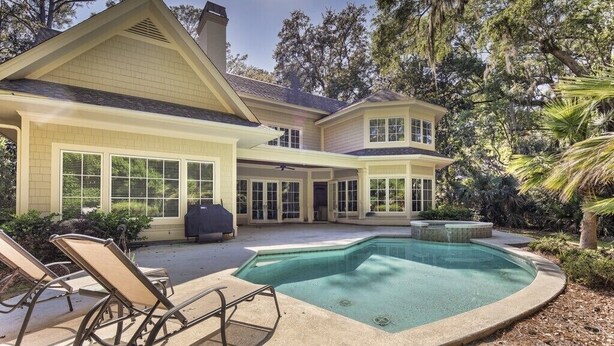 A two-story house with a swimming pool, outdoor seating, and a covered patio area. - 34 Baynard Cove Rd. at The Sea Pines Resort (Hilton Head Island)