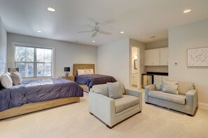 A bedroom with a bed, two chairs, a ceiling fan, and a window. - 68 Shell Ring Rd. at The Sea Pines Resort (Hilton Head Island)
