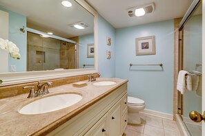 A bathroom with two sinks, a toilet, and a shower. - 238 Stoney Creek at Sea Pines Resort (Hilton Head Island)