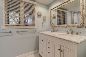 A bathroom with a vanity, a large mirror, and a window with blinds. - 241 Stoney Creek at Sea Pines Resort (Hilton Head Island)