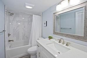 A modern bathroom with a shower, toilet, and vanity. - 524 Plantation Club Villas at The Sea Pines Resort (Hilton Head Island)