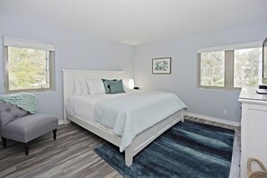 A bedroom with a bed, a chair, a desk, and a window. - 524 Plantation Club Villas at The Sea Pines Resort (Hilton Head Island)