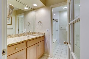A bathroom with a sink, mirror, and shower. - 552 Ocean Course at Sea Pines Resort (Hilton Head Island)