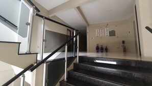 A modern staircase with black railings and marble steps leading to a landing. - Pousada Vila do Porto (Ipojuca)
