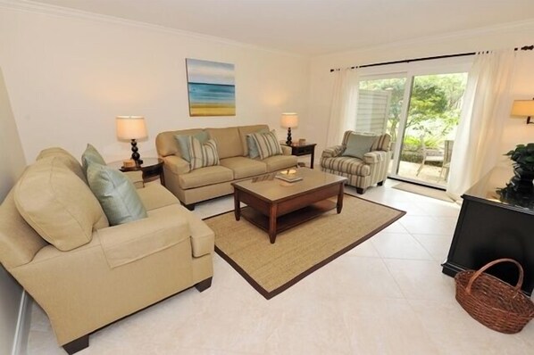 A living room with a sofa set, a coffee table, and a TV stand. - 2219 Heritage at The Sea Pines Resort (Hilton Head Island)