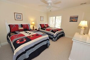 A bedroom with two beds, a ceiling fan, and a window. - 2219 Heritage at The Sea Pines Resort (Hilton Head Island)