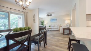 A modern kitchen with a dining area, a ceiling fan, and a view of the outdoors. - 2270 Heritage at The Sea Pines Resort (Hilton Head Island)