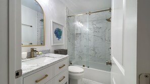 A modern bathroom with a marble vanity, a glass shower enclosure, and a white toilet. - 2309 Heritage at The Sea Pines Resort (Hilton Head Island)