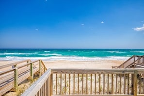 A wooden boardwalk leading to a sandy beach with the ocean in the background. - OCEANFRONT, Gorgeous Views + Linens Included! (Surf City)