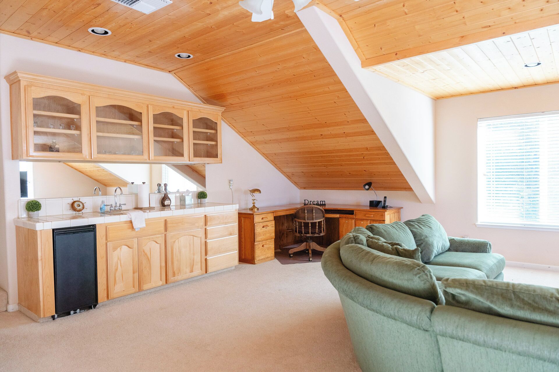 A spacious loft with a kitchen, dining area, and a cozy seating area.