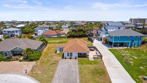 A residential area with houses, a driveway, and a clear sky. - SP615  Pet Friendly, In Town, Near Beach (Port Aransas)
