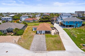 A residential area with houses, a driveway, and a clear sky. - SP615  Pet Friendly, In Town, Near Beach (Port Aransas)