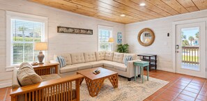A living room with a sectional sofa, wooden coffee table, and a small side table. - SP615  Pet Friendly, In Town, Near Beach (Port Aransas)