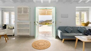 A modern living room with a sofa, a coffee table, and a dining area with chairs and a table. - Stunning private villa for 4 guests with WIFI, private pool, A/C, TV and terrace (Torrox)