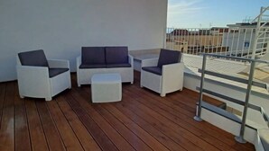 A rooftop deck with outdoor furniture, a chimney, and a clear sky. - Lovely apartment for 5 guests with WIFI, A/C, TV and terrace (Meta)