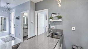 A modern kitchen with a granite countertop, stainless steel sink, and a built-in oven. - Modern Las Vegas Home w/ Patio: 10 Mi to The Strip (Las Vegas)