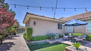 A patio with a brick pathway, a small lawn, and outdoor furniture. - Modern Las Vegas Home w/ Patio: 10 Mi to The Strip (Las Vegas)
