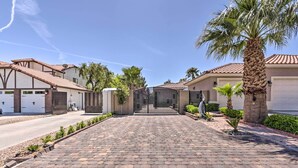 A residential driveway with a paved walkway, a gated entrance, and a palm tree. - Modern Las Vegas Home w/ Patio: 10 Mi to The Strip (Las Vegas)