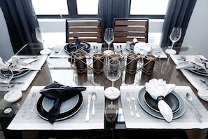 A dining table set for four with a modern, geometric centerpiece.