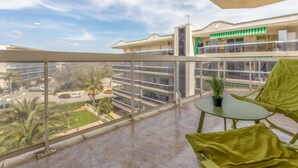 Un balcone con vista su un edificio e un parcheggio.