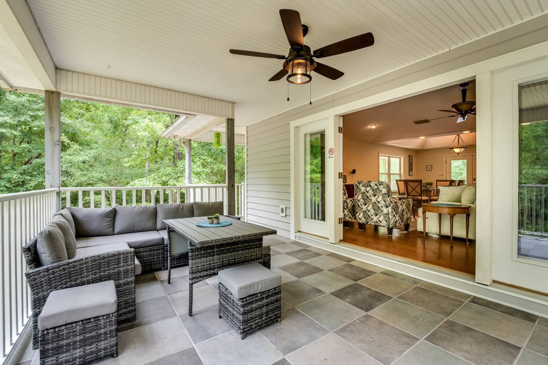Porch Retreat: Relax on the spacious porch with lush views and stylish outdoor seating!