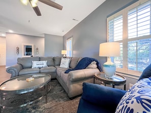 Relax in this stylish living room with a comfortable sofa, coffee table, and side table, perfect for unwinding.
