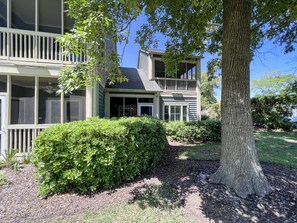 Stunning two-story home with a spacious balcony and beautifully manicured lawn.