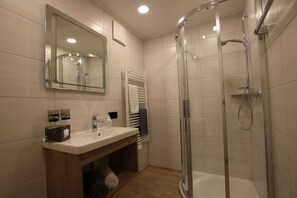 Shower, hair dryer, towels, toilet paper