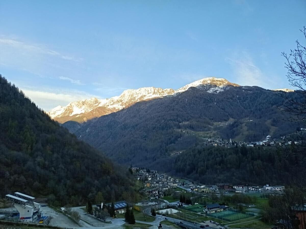 A mountainous landscape with a village nestled in the valley.